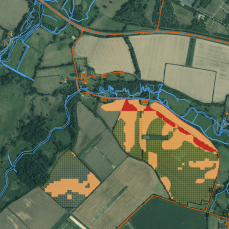 Figure 8: Finer grained risk map derived from Hampshire data (20m elevation model, field boundaries from aerial imagery). Moderate risk shown in orange, greatest risk in red. Hashed areas are oilseed rape fields. [Contains Ordnance Survey data © Crown copyright and database right 2014. Contains public sector information licensed under the Open Government Licence v2.0].